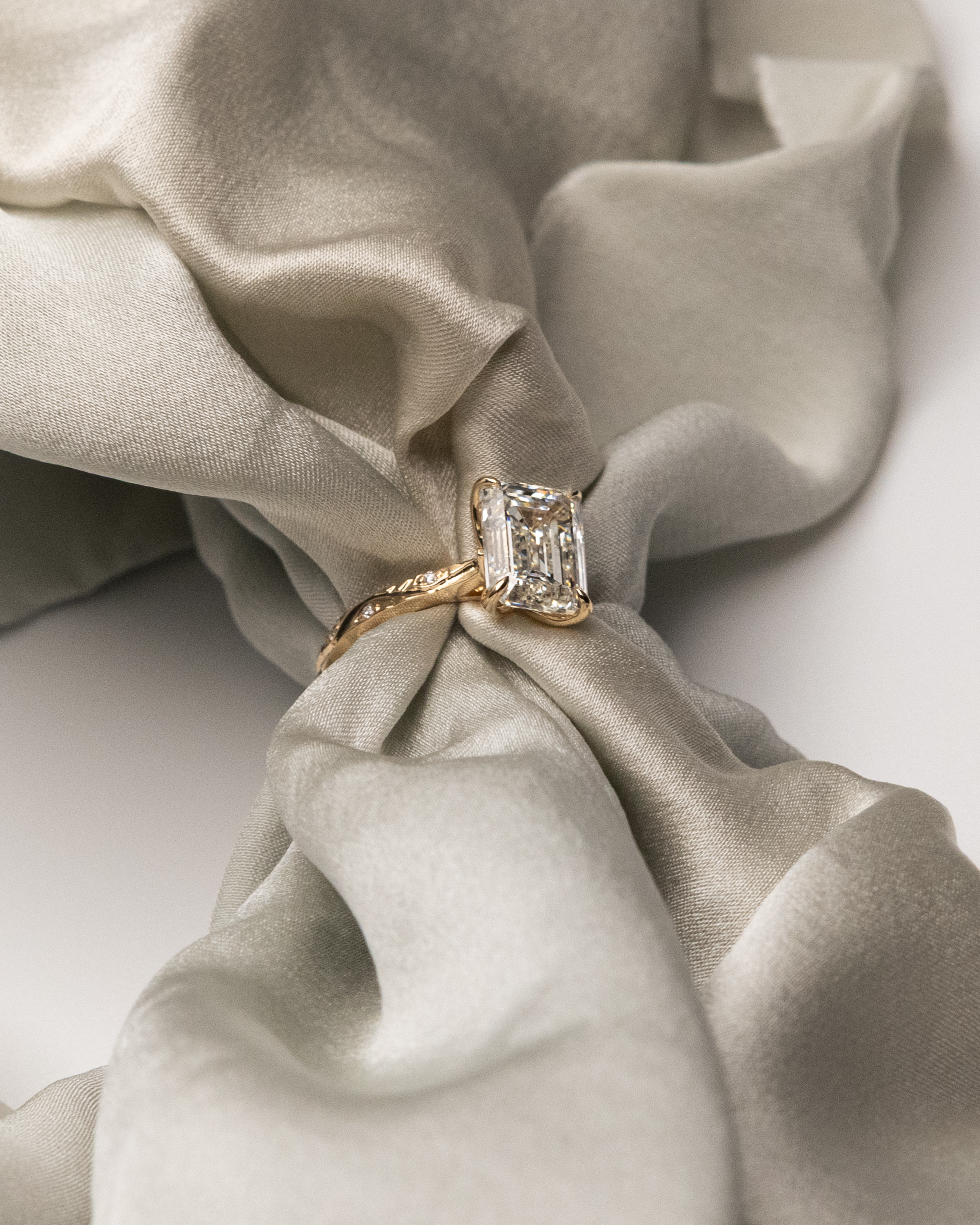 Emerald cut diamond engagement ring in yellow gold — are lab grown diamonds real guide by Kalakari